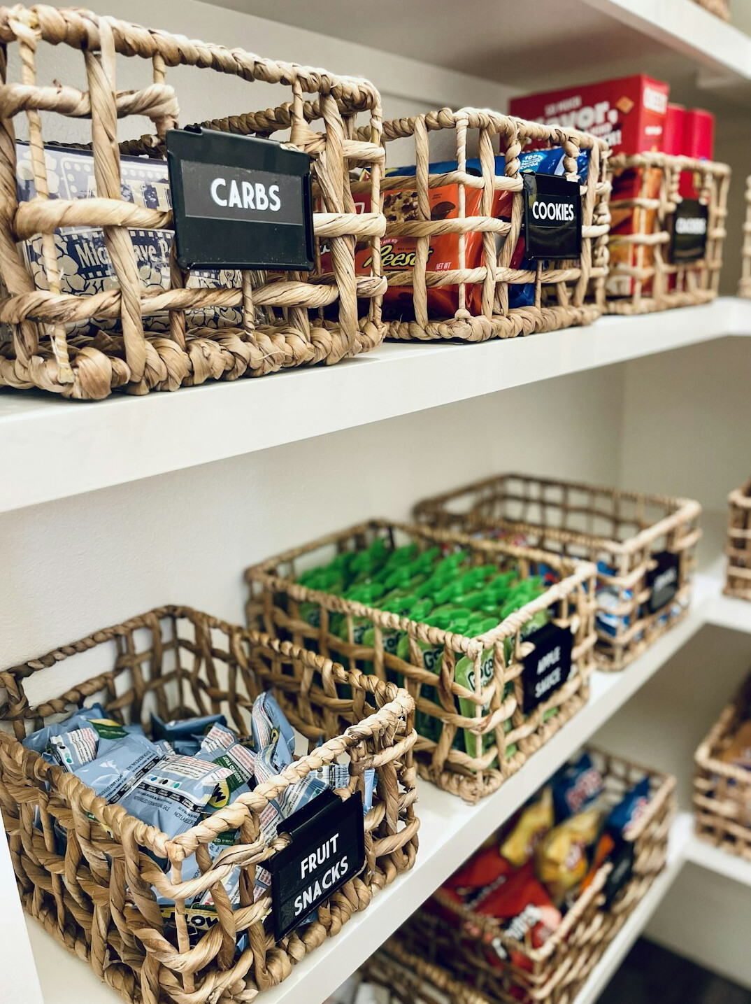 Pantry shelves with labelled glass jars and baskets