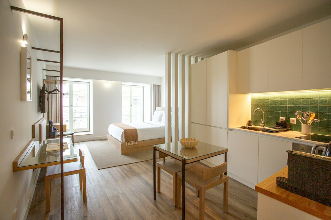 Compact studio apartment with sofa bed and shelves