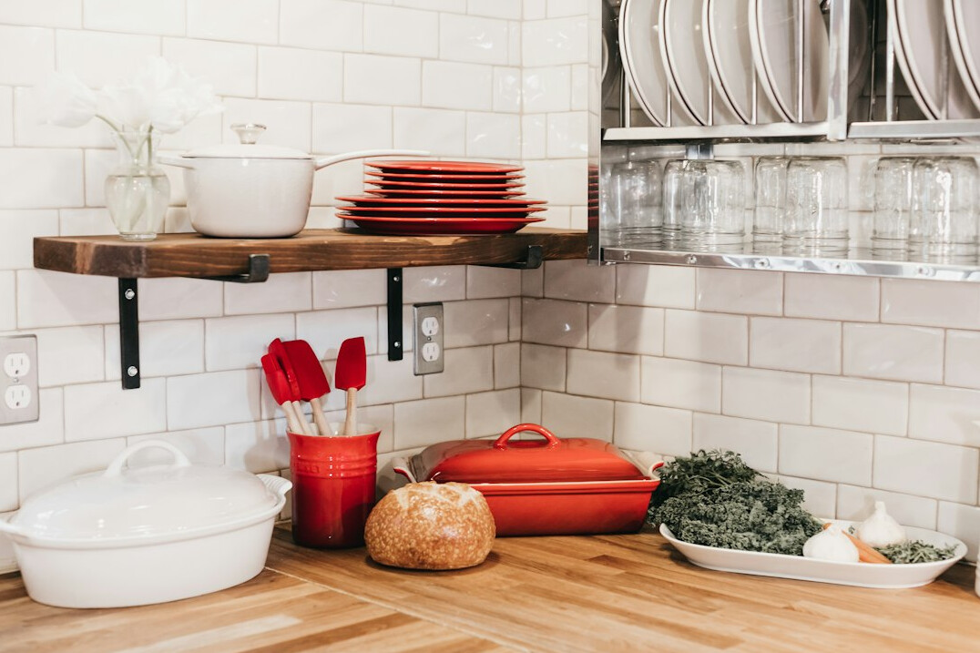 White kitchen with open shelves and kitchen utensils