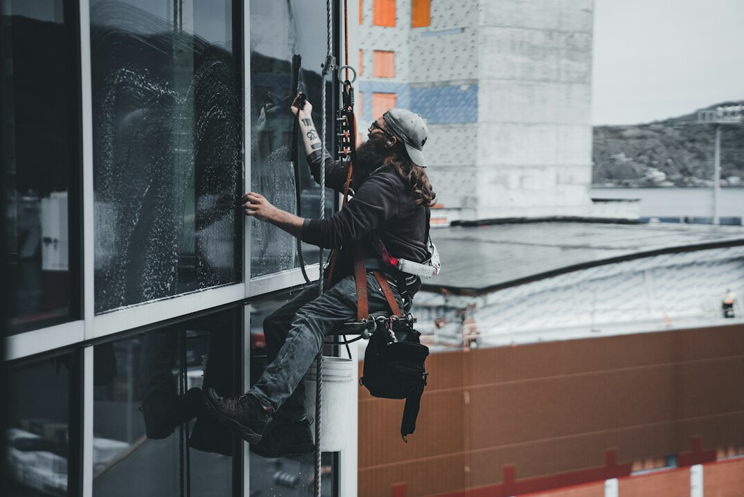 woman cleaning window with natural solution
